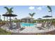 Community pool with plenty of lounge chairs and umbrellas for shade at 8572 Daybreak St, Sarasota, FL 34241