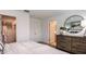 Spacious bedroom with dresser and en-suite bathroom at 8716 Winter Breeze Way, Sarasota, FL 34241