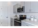 Modern kitchen with gray cabinets and stainless steel appliances at 8724 Winter Breeze Way, Sarasota, FL 34241