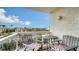 Private balcony with table and chairs, offering a neighborhood view at 1000 Longboat Club Rd # 304, Longboat Key, FL 34228