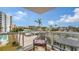 Private balcony with table and chairs, offering a neighborhood view at 1000 Longboat Club Rd # 304, Longboat Key, FL 34228