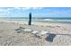 Relaxing beach access with lounge chairs and umbrella at 1000 Longboat Club Rd # 304, Longboat Key, FL 34228