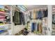 Large closet with shelves and hanging space for clothes and shoes at 1000 Longboat Club Rd # 304, Longboat Key, FL 34228