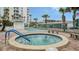 Community hot tub with surrounding brick patio and benches at 1000 Longboat Club Rd # 304, Longboat Key, FL 34228