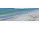 Peaceful ocean waves lapping the sandy shore at 1000 Longboat Club Rd # 304, Longboat Key, FL 34228