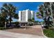 Gated parking entrance with brick pavers and tropical landscaping at 1000 Longboat Club Rd # 304, Longboat Key, FL 34228