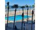 Inviting pool area with ocean views and palm trees at 1000 Longboat Club Rd # 304, Longboat Key, FL 34228