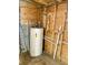 Unfinished mechanical room housing water heater at 10607 3Rd St, Thonotosassa, FL 33592