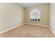 Bright bedroom featuring carpet and an arched window at 1104 83Rd Nw St, Bradenton, FL 34209