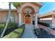 Elegant entryway with arched columns, double doors, and lush landscaping at 1104 83Rd Nw St, Bradenton, FL 34209