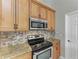 Kitchen features stainless steel appliances and light wood cabinets at 1104 83Rd Nw St, Bradenton, FL 34209