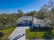 Single-story house with gray roof, driveway, and lush green lawn at 11264 28Th Street E Cir, Parrish, FL 34219