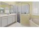 Bathroom with soaking tub, walk-in shower, and double vanity at 11264 28Th Street E Cir, Parrish, FL 34219