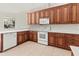 Kitchen corner with white appliances and wood cabinets at 11264 28Th Street E Cir, Parrish, FL 34219