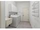 Laundry room with washer, dryer, and storage cabinets at 11264 28Th Street E Cir, Parrish, FL 34219