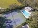 Two tennis courts and community pool with covered seating area at 11264 28Th Street E Cir, Parrish, FL 34219