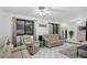 Spacious living room with beige leather furniture and a ceiling fan at 1170 Richter St, Port Charlotte, FL 33952