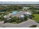 Community pool and clubhouse with surrounding amenities at 11712 Golden Bay Pl, Bradenton, FL 34211