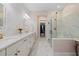 Elegant bathroom with double vanity, marble floors, and a walk-in shower at 11712 Golden Bay Pl, Bradenton, FL 34211