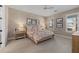 Bedroom with floral bedding, wood dresser, and windows with plantation shutters at 11712 Golden Bay Pl, Bradenton, FL 34211