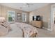 Bedroom with TV, dresser and large windows with plantation shutters at 11712 Golden Bay Pl, Bradenton, FL 34211