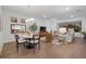 Bright dining area with round table and chairs, hardwood floors, and view into living room at 11712 Golden Bay Pl, Bradenton, FL 34211