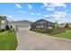 Single-Gathering home with paver driveway, garage, and screened pool area at 11712 Golden Bay Pl, Bradenton, FL 34211