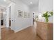 Light and bright hallway with wood floors and decorative console table at 11712 Golden Bay Pl, Bradenton, FL 34211