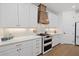 Well-equipped kitchen with modern range, white cabinets and quartz countertops at 11712 Golden Bay Pl, Bradenton, FL 34211