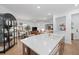 Modern kitchen with white cabinets, quartz countertops, and a large island at 11712 Golden Bay Pl, Bradenton, FL 34211