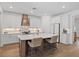 Bright kitchen featuring white cabinets, an island with seating, and wood flooring at 11712 Golden Bay Pl, Bradenton, FL 34211