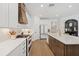 Modern kitchen with white cabinets, quartz countertops, and a large island at 11712 Golden Bay Pl, Bradenton, FL 34211