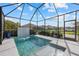 Relaxing screened-in pool with a tiled waterfall and spacious deck at 11712 Golden Bay Pl, Bradenton, FL 34211