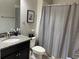 Clean bathroom with granite countertop, shower, and gray shower curtain at 12315 Ballentrae Forest Dr, Riverview, FL 33579