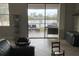 Living room with sliding glass doors offering a lake view and patio access at 12315 Ballentrae Forest Dr, Riverview, FL 33579