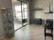 Living room with sliding glass doors to a patio, gray tile floors, and a pet carrier at 12315 Ballentrae Forest Dr, Riverview, FL 33579