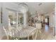 Bright dining room with round table and view of the kitchen and sunroom at 13823 Swiftwater Way, Bradenton, FL 34211