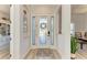 Bright entry with elegant glass front door and wood-look floors at 13823 Swiftwater Way, Bradenton, FL 34211