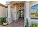 Elegant entryway with a double door and decorative columns at 13823 Swiftwater Way, Bradenton, FL 34211