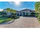 Two-story home with tile roof, paver driveway, and palm trees at 13823 Swiftwater Way, Bradenton, FL 34211