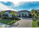 Two-story home with tile roof, paver driveway, and palm trees at 13823 Swiftwater Way, Bradenton, FL 34211