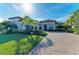 Two-story home with tile roof, paver driveway, and palm trees at 13823 Swiftwater Way, Bradenton, FL 34211