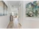 Light and bright hallway with art and access to bedrooms at 13823 Swiftwater Way, Bradenton, FL 34211