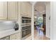 Kitchen features double ovens, custom cabinetry and a view to the dining area at 13823 Swiftwater Way, Bradenton, FL 34211