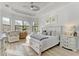 Spacious main bedroom with large windows, tray ceiling and light wood furnishings at 13823 Swiftwater Way, Bradenton, FL 34211