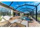 Enclosed patio area with pool, spa, and lounge chairs overlooking lake at 13823 Swiftwater Way, Bradenton, FL 34211