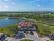 Aerial view of a home with lush landscaping and a tranquil lake at 14081 Black Beauty Dr # 1111, Punta Gorda, FL 33955