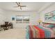 Bright bedroom features a ceiling fan, cozy bedding and view of a serene lake at 14081 Black Beauty Dr # 1111, Punta Gorda, FL 33955