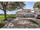 Lovely townhome with a brick driveway leading to two-car garages, complemented by lush landscaping and serene lake views at 14081 Black Beauty Dr # 1111, Punta Gorda, FL 33955