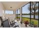 Relaxing screened lanai featuring seating and tranquil lake views at 14081 Black Beauty Dr # 1111, Punta Gorda, FL 33955